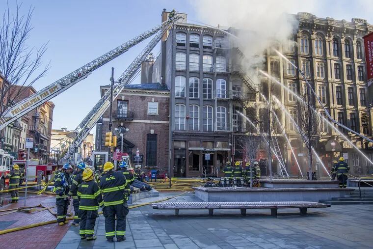 Philadelphia Firefighters use water hoses to attack the latest fire in Old City, which started in an apartment building on the 200 block of Chestnut Street,