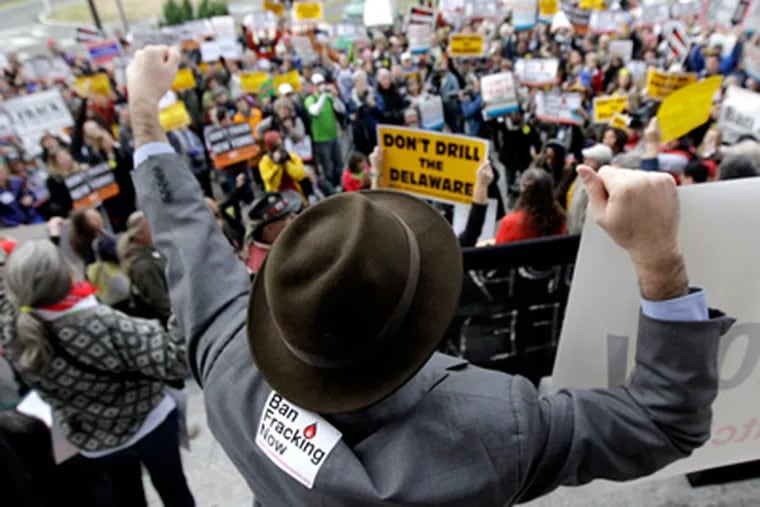 Eric Weltman, an organizer with Food and Water Watch, chants along with a crowd opposing natural gas drilling in the Delaware River watershed during a rally, Monday, Nov. 21, 2011 in Trenton, N.J. (AP Photo/Julio Cortez)