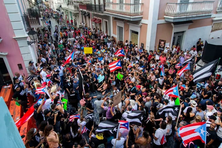 Demonstrators protest against Gov. Ricardo Rossello in San Juan, Puerto Rico on Sunday.