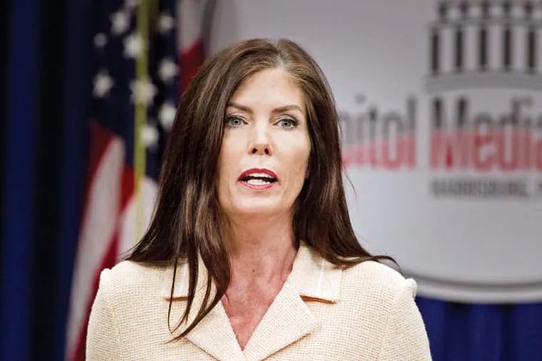 Pa. Attorney General Kathleen G. Kane reads her statement at the Capitol Media Center in Harrisburg. She is charged with conspiracy and other crimes. (ED HILLE / Staff Photographer)