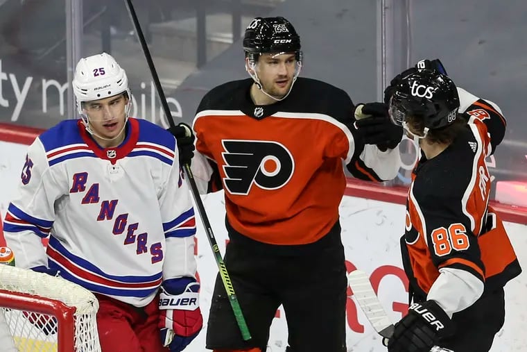 Flyers left winger James van Riemsdyk (center) celebrates his goal against the Rangers with linemate Joel Farabee on Wednesday.
