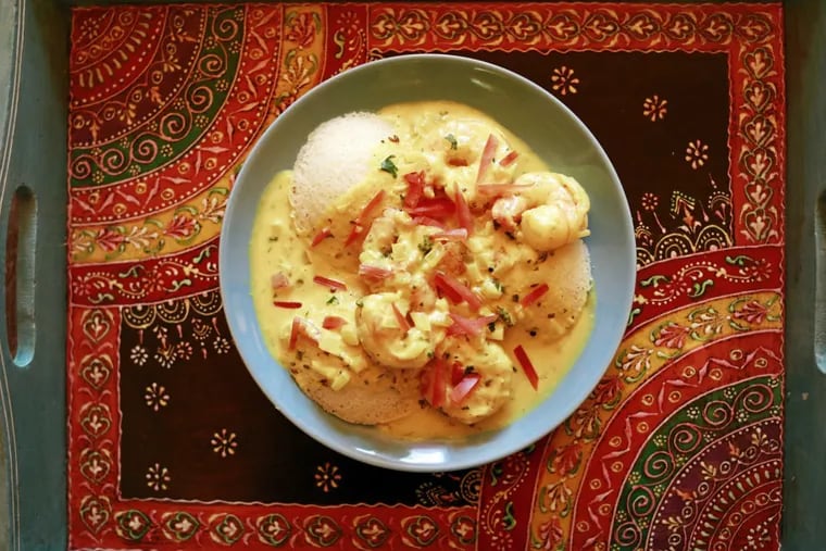 Chaat & Chai's poached shrimp in turmeric-tinted coconut sauce over idli rice-and-lentil cakes.