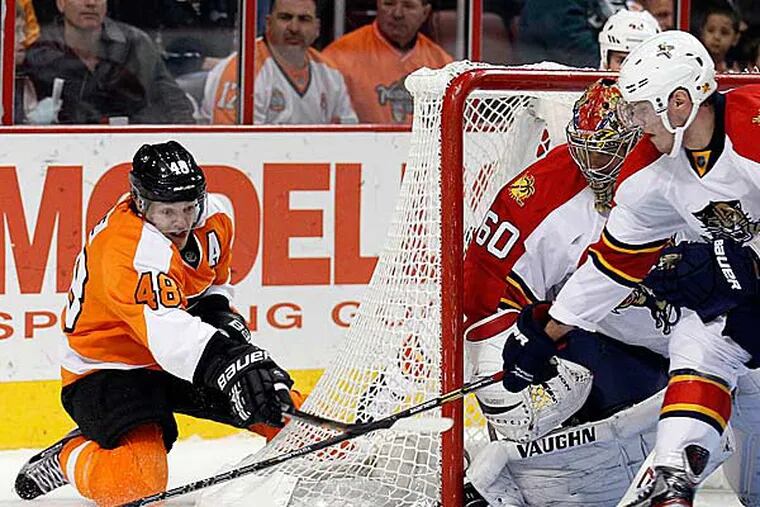 Danny Briere watches the puck against Florida Panthers goalie Jose Theodore and Dimitry Kulikov in the third period on Thursday, February 7, 2013. (Yong Kim/Staff Photographer)