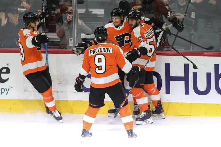 The Flyers' Travis Konecny (center) celebrates his power-play goal with teammates against the Golden Knights during the first period Monday at the Wells Fargo Center.