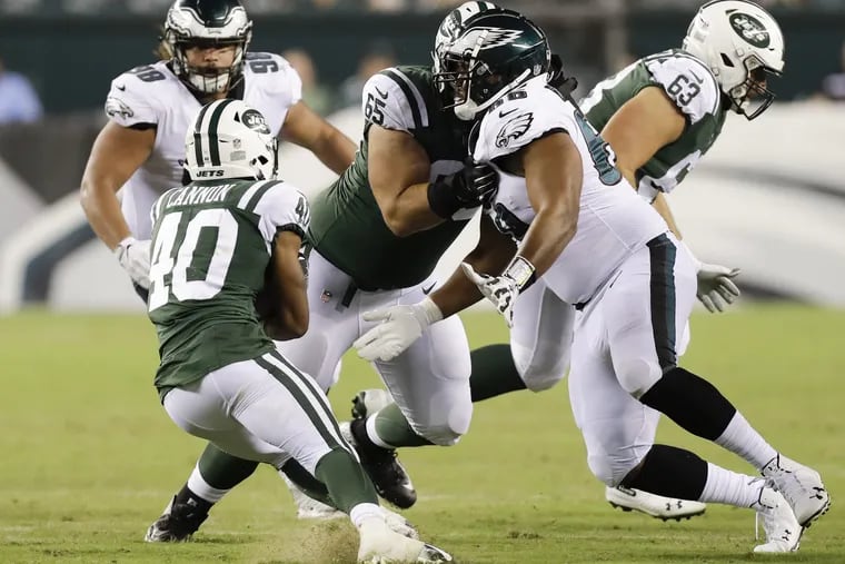 Eagles defensive tackle Bruce Hector goes after New York Jets running back Trenton Cannon during a preseason game on Thursday, August 30, 2018. YONG KIM / Staff Photographer