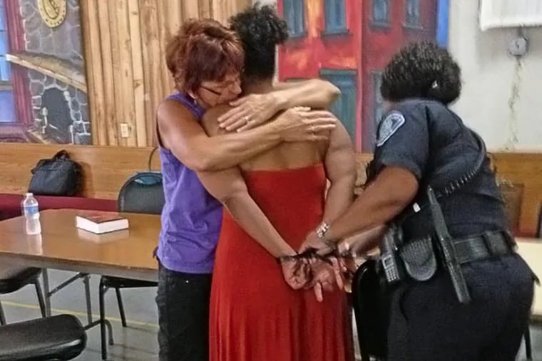Volunteer Helen Seybert, left, hugs a woman arrested in a prostitution sweep this week. The woman, who called herself 'Jojo,' was offered rehab in lieu of charges as part of a new initiative between police, prosecutors and community members. Five women opted to go to rehab, though Jojo was not one of them. Staff photo by Julia Terruso