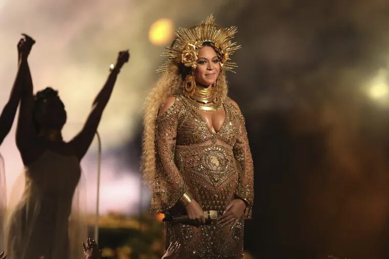 FILE – This Feb. 12, 2017, file photo shows Beyonce performing at the 59th annual Grammy Awards in Los Angeles. Beyonce debuted her newborn twins Sir Carter and Rumi in an Instagram post on July 13, 2017.