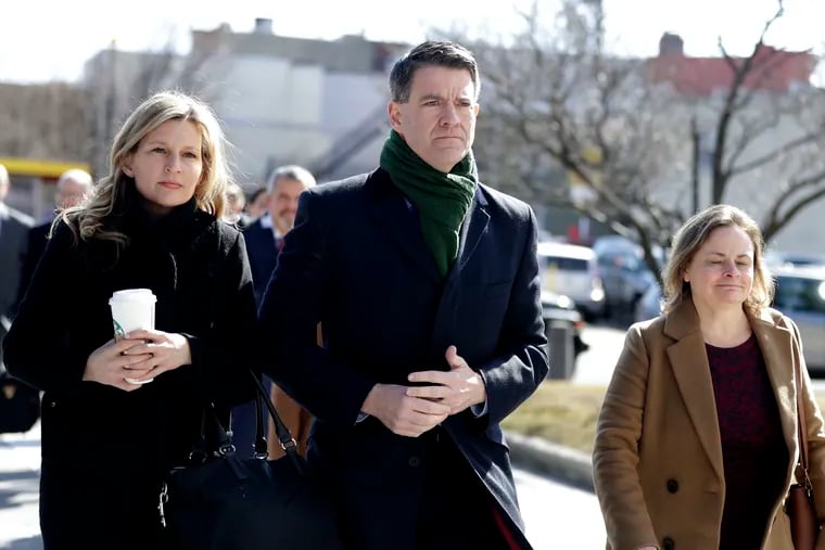Bill Baroni, center, arrives at the Martin Luther King, Jr., Federal Courthouse ahead of a court appearance, Tuesday, Feb. 26, 2019, in Newark, N.J. Baroni, a high-ranking appointee of former New Jersey Gov. Chris Christie, was sentenced to 18 months' imprisonment in the Bridgegate scandal.