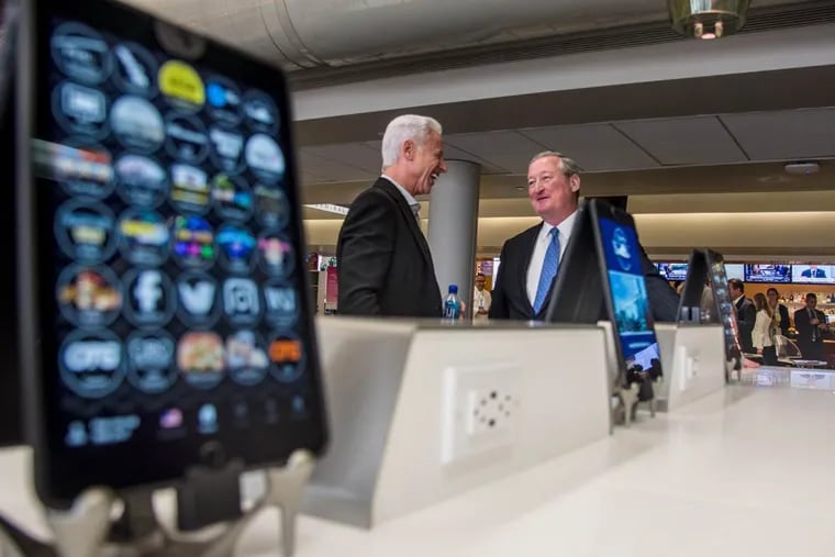 Among a few of the thousands of Terminal B’s newly-installed iPads, Mayor Kenney (right) talks with Rick Blatstein, OTG founder and CEO, before Monday’s ribbon cutting at PHL.