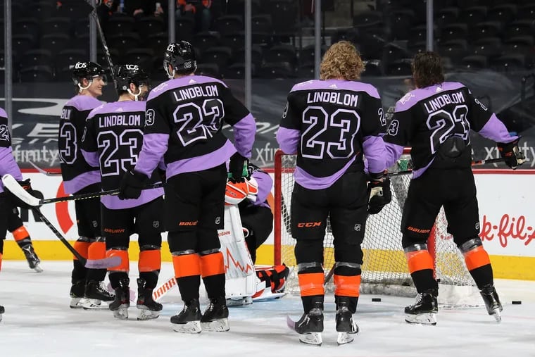Members of the Flyers are shown during warmups prior to their game against the New York Islanders wearing the jersey of their teammate Oskar Lindblom on April 18.