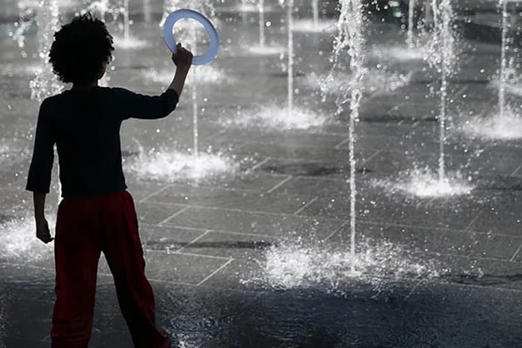 Marlowe Deriser, 6, of Center City, plays in the water at the interactive fountain in City Hall's Dilworth Plaza.