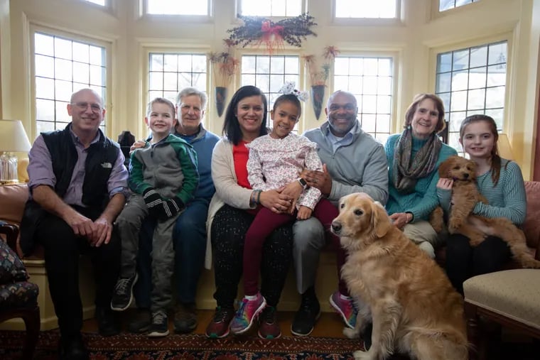 (Left to right) Michael Aichenbaum, executive director of Hosts for Hospitals, Colin Dilenschneider, 7, Jim Gould, Adayna Commodore, Nila Commodore, 8, Travis Commodore, Page Talbott, and Megan Dilenschneider, 10, at Gould and Talbott's home in Balla Cynwyd, Sunday, February 17, 2019. Page Talbott and her husband, Jim Gould, volunteer with Hosts For Hospitals, which provides overnight accommodation in private homes for out-of-town patients and families receiving care in Philly-area hospitals, and the Commodores, who live in Charlotte, NC, are currently staying there while their 23-month-old daughter, Elsie, is being treated at CHOP.