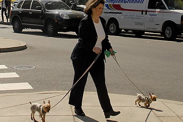New city managing director Camille Cates Barnett takes advantage of a break between meetings to walk her two dogs. (Tom Gralish/Inquirer)