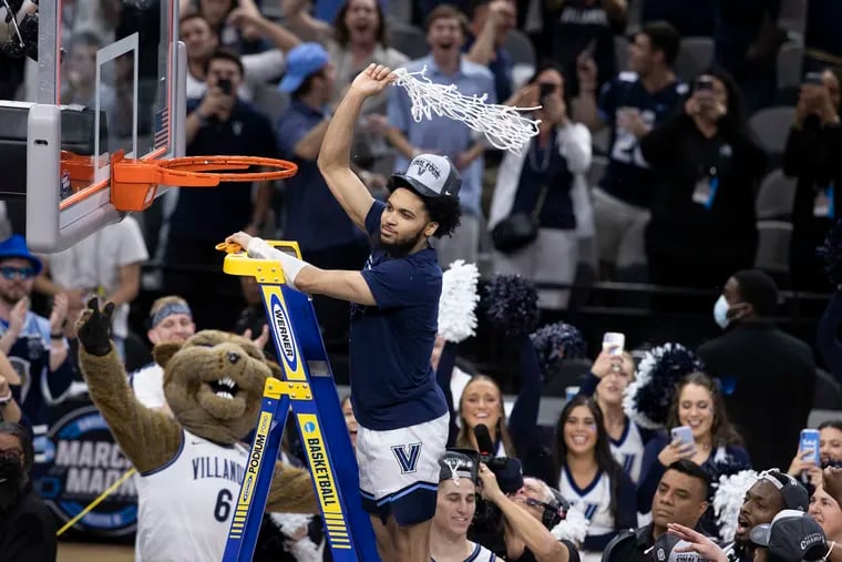 Caleb Daniels makes the final cut on the net as Villanova celebrates after winning the South Regional championship game in the NCAA Tournament on March 26, 2022 at AT&T Arena in San Antonio, Texas. They will advance to the Final Four in New Orleans.