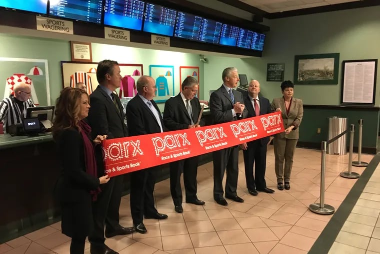 Tony Ricci, center, chief executive of Parx Casino, welcomes bettors at the official opening of the Parx Race and Sportsbook at the South Philadelphia Turf Club on Thursday. "You can finally make a legal sports bet in South Philadelphia," said Ricci, a native of South Philadelphia.