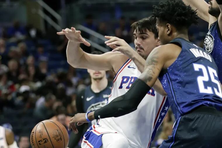 Sixers’ forward Dario Saric, left, loses control of the ball as he tries to get past Magic forward Wesley Iwundu during the first half of the Sixers’ win on Thursday.