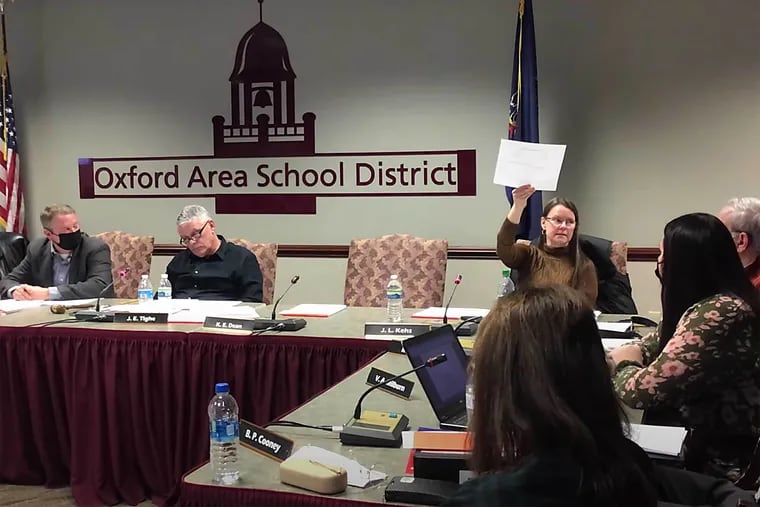 Jennifer Kehs holds up what she described as a chart showing academic decline in the Oxford Area School District during a Jan. 18 school board meeting.