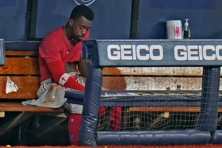 Andrew McCutchen wipes his face in the dugout after the Phillies lost Saturday night.