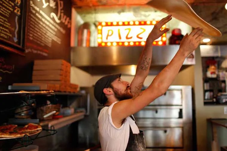 Tony Montagnaro throws a pizza at Pizza Brain. ( Michael S. Wirtz /
Staff Photographer )