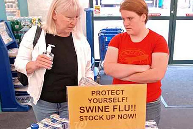 In this April 2009 photo, Newark, Del. residents Debbie Henderson and her daughter Regina, 16, buy supplies to guard against picking up the swine flu virus. ( Clem Murray / Staff Photographer / file)