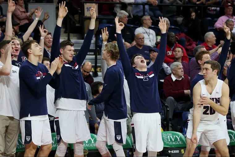 Penn players celebrating a point from the bench during their Ivy League tournament semifinal game against Yale at the Palestra on Saturday.