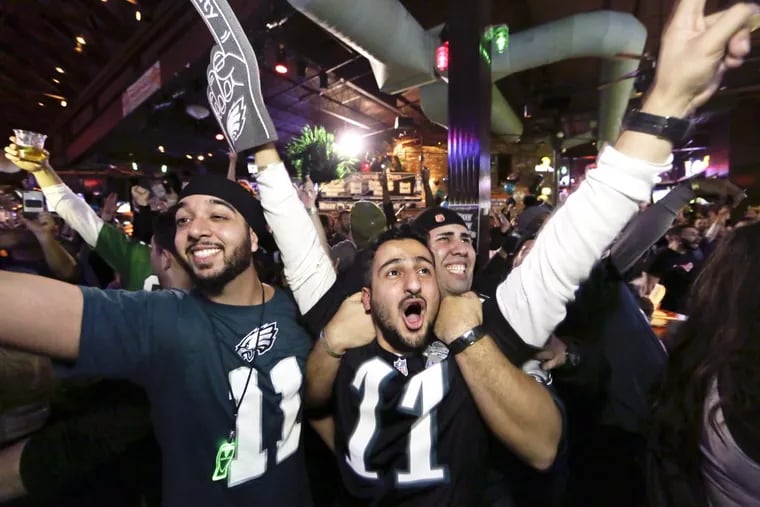 Eagles fans including Abhi Luthra of Washington D.C. (in foreground) cheer wildly for the Eagles at Chickie's and Pete's in South Philadelphia during Super Bowl LII 2018.