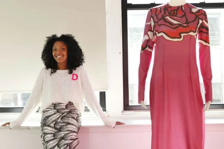 Designer Dom Streater with a dress, topped with a big rose print from shoulder to shoulder, from her Prima line. (Michael S. Wirtz/Staff Photographer)