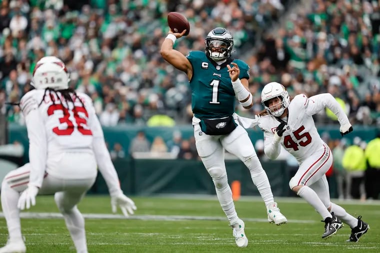 Eagles quarterback Jalen Hurts scrambles and throws for a touchdown to Julio Jones during the loss to the Arizona Cardinals on Dec. 31.