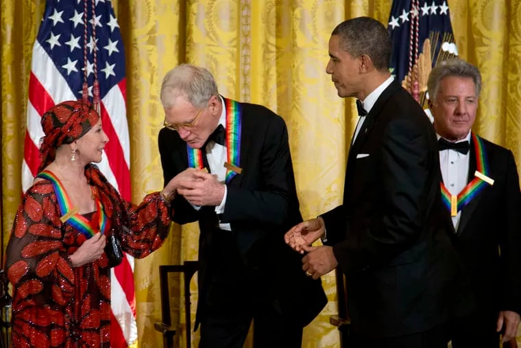 President Obama watches as David Letterman kisses the hand of dancer Natalia Makarova during a White House reception. At right is Dustin Hoffman.