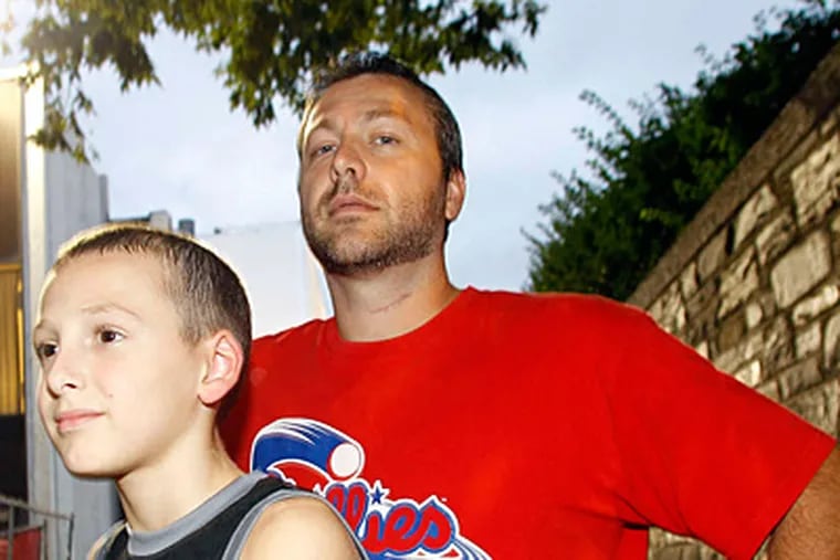 Brian Walsh and son Dalton, who say they were stranded by cops after a stop. (Yong Kim/Staff)