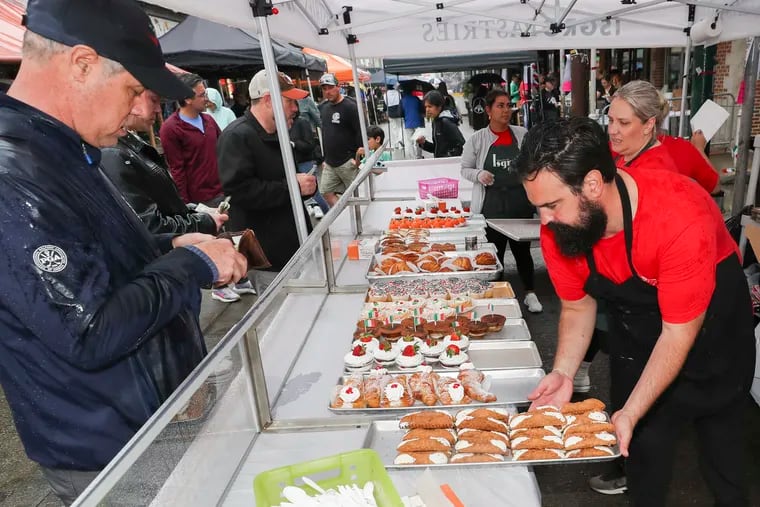 People line up to buy Isgro Pastries at the annual Italian Market Festival in Philadelphia in May 2023.