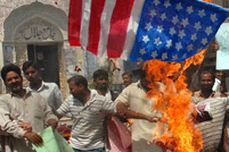 Pakistanis burn a U.S. flag and an effigy of President Bush to protest strikes in tribal areas along the Afghanistan border.