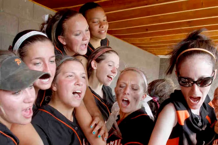 Pennsbury players huddle in the dugout after beating Souderton, 5-0, to advance to the state Class AAAA semifinals.