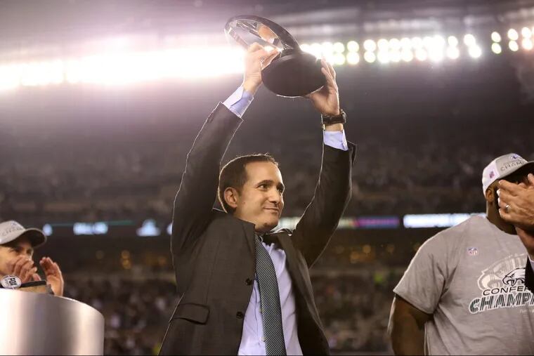 Howie Roseman, here lifting the NFC championship trophy, took advantage of the ability to roll over unused cap space from one year to the next.