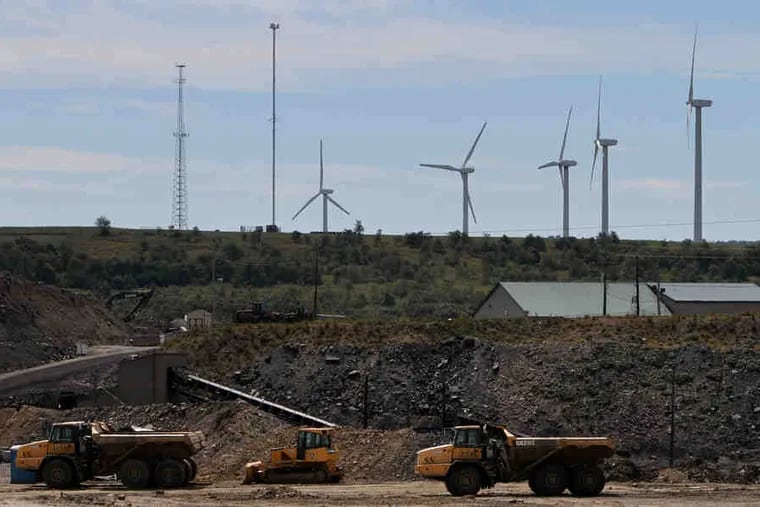 Wind turbines rise behind the Kimberly Run coal mine in Friedens, Somerset County. Joining the Regional Greenhouse Gas Initiative would cap the amount of carbon that coal and other power plants in Pennsylvania can emit.