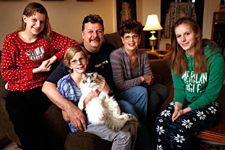 Stephen and Trish Luberda with their children (from left) Sierra, 14; Makena, 11; and Karlee, 17, at their home in Reading. Like nearly 10 percent of the nation's children ages 2 to 17, Makena and Karlee have ADHD. (Laurence Kesterson / Staff Photographer)