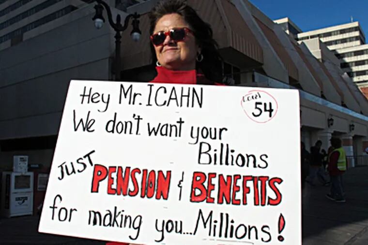 Shirley Costello, a bartender at the Tropicana, holds a sign critical of owner Carl Icahn's plan to eliminate workers' pensions in favor of direct cash payments. WAYNE PARRY / Associated Press