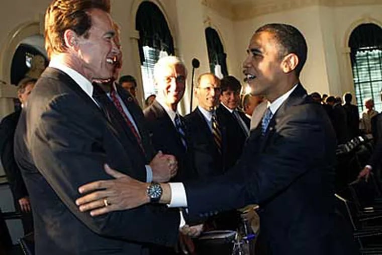 President-elect Barack Obama, right, greets California Gov. Arnold Schwarzenegger, left, at Congress Hall today. (AP / Pablo Martinez Monsivais)