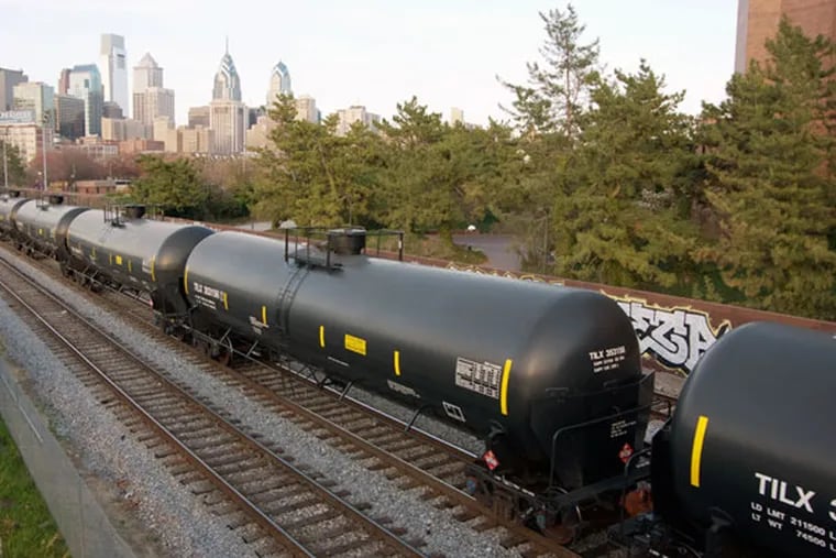 An oil train passes through Philadelphia. Regulators have decided not to make suggested changes in disclosure regulations for trains carrying crude oil from North Dakota that were
instituted in 2014. State commissions will remain informed. (JON SNYDER / File Photograph)