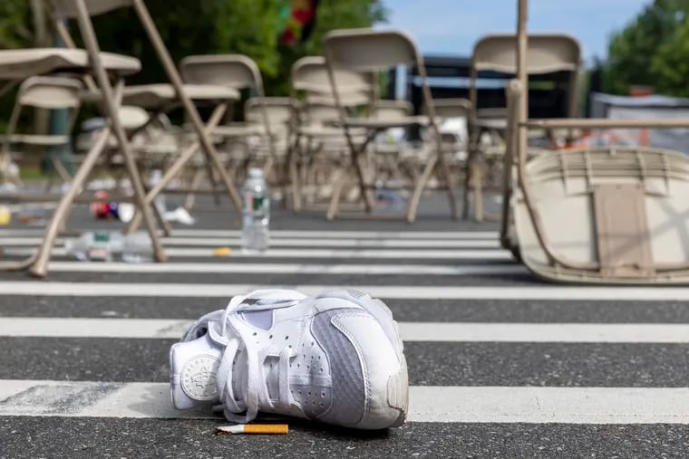 A sneaker was left behind in the seating area near stage where live music was playing during fire works. The scene around the Philadelphia Museum of Art, Ben Franklin Parkway and Eakins Oval on the morning after two Philadelphia police officers were injured by gun fire during the 4th of July celebration and fireworks on the Ben Franklin Parkway.