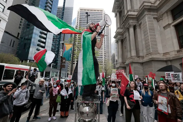 Qais Dana of Philadelphia gets people chanting “Palestine will be free” before the free Palestine march begins from City Hall in Philadelphia on Thursday.
