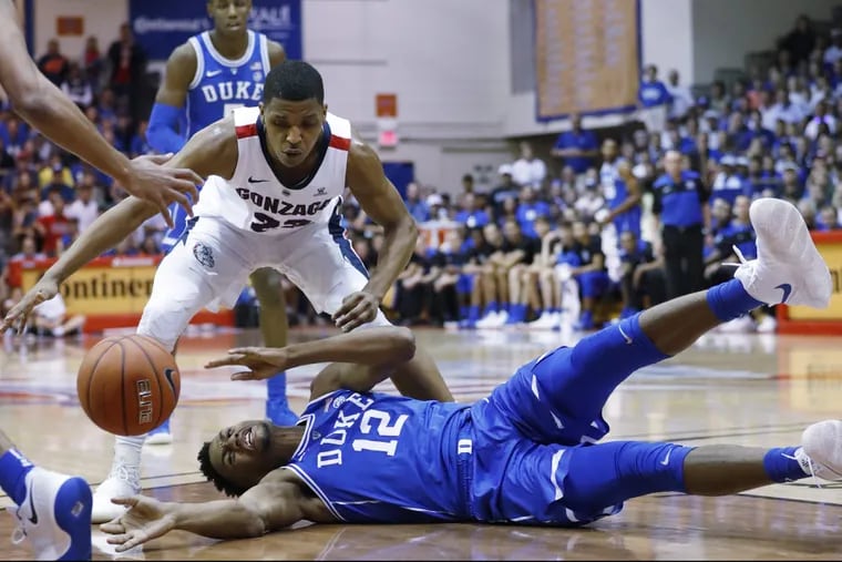 Duke forward Javin DeLaurier (12) loses the ball while being guarded by Gonzaga guard Zach Norvell Jr.
