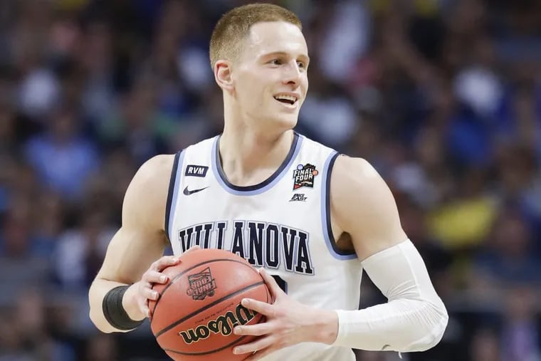 Villanova guard Donte DiVincenzo smiling while holding the basketball during Monday’s championship game against Michigan.