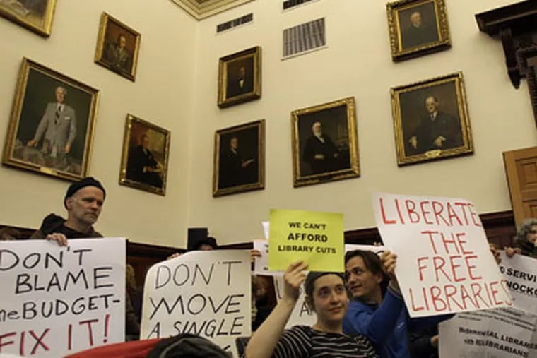 A crowd gathers inside room 202 in City Hall to protest the closing of 11 branches of the Free Library of Philadelphia before Mayor Michael
Nutter's news conference on Monday. (David Maialetti / Staff Photographer)