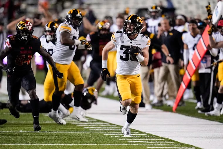 Iowa defensive back Quinn Schulte runs with the ball after making an interception against Maryland on Friday night.