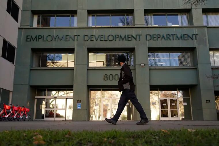 In this Dec. 18, 2020 photo, a person passes the office of the California Employment Development Department in Sacramento.