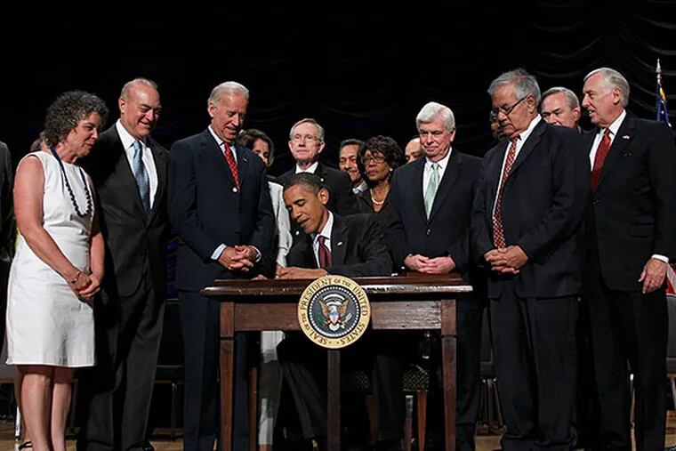 President Obama signs Dodd-Frank in 2010. PABLO MARTINEZ MONSIVAIS / Associated Press