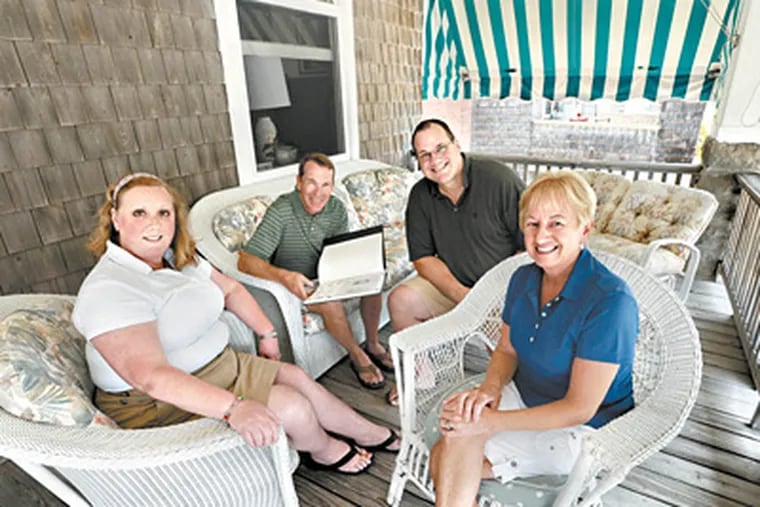 On the front porch of the Andrews' century-old beach house (from left to right): Angie Andrews; C.B. Silcox; Evan Andrews; and Sally Silcox. (April Saul / Staff Photographer)