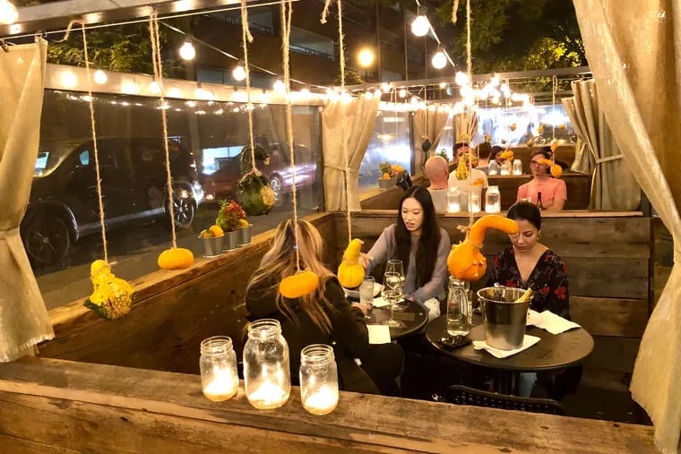 The streetery at Pumpkin BYOB, at 1713 South St., is built into the parking lane with reclaimed wood from a 150-year-old barn and a clear vinyl siding to shield diners from traffic fumes.
