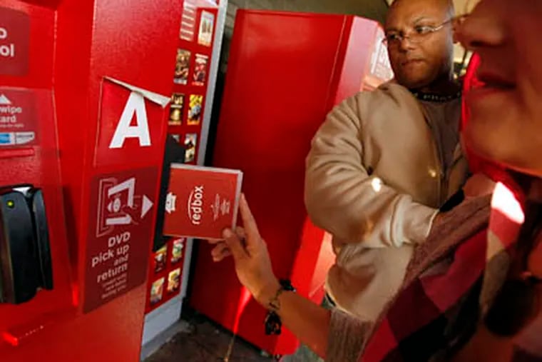 FILE: Enrique Cruz, left, and his wife Darlene Cruz return some DVD&apos;s at the Red Box movie rental vending machines outside Tony&apos;s Finer Foods on 4600 W. Belmont, Oct. 6, 2009, in Chicago, Illinois. (Phil Velasquez / Chicago Tribune / MCT)